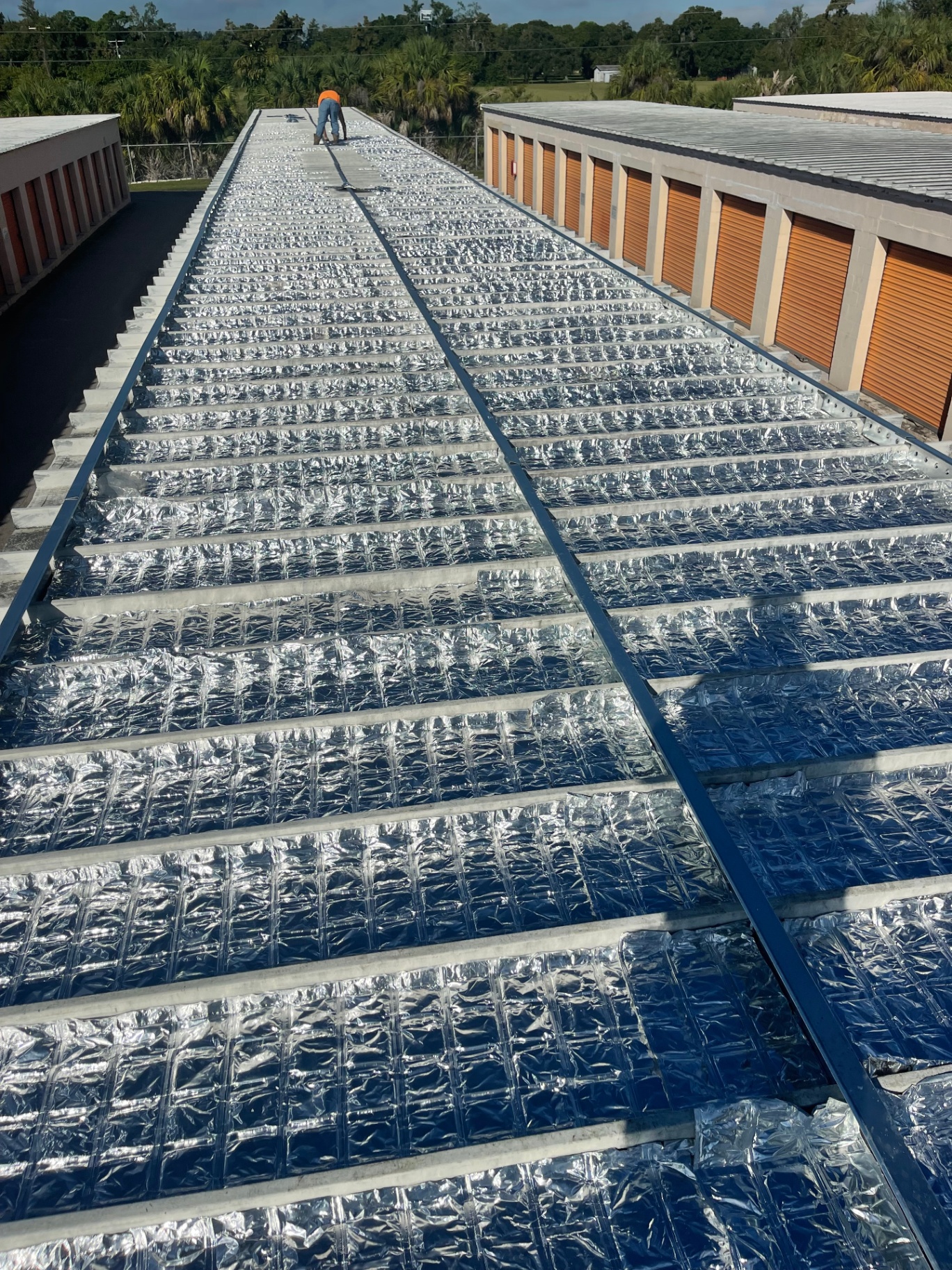 EnigMat PCM thermal blanket roll in a sunlit industrial interior